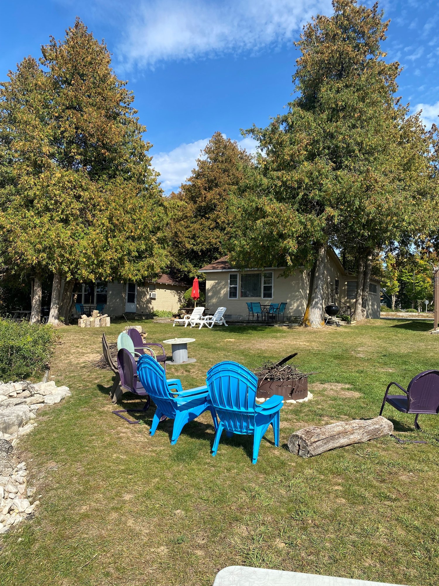 patio chairs by fire pit at Island View Cottage