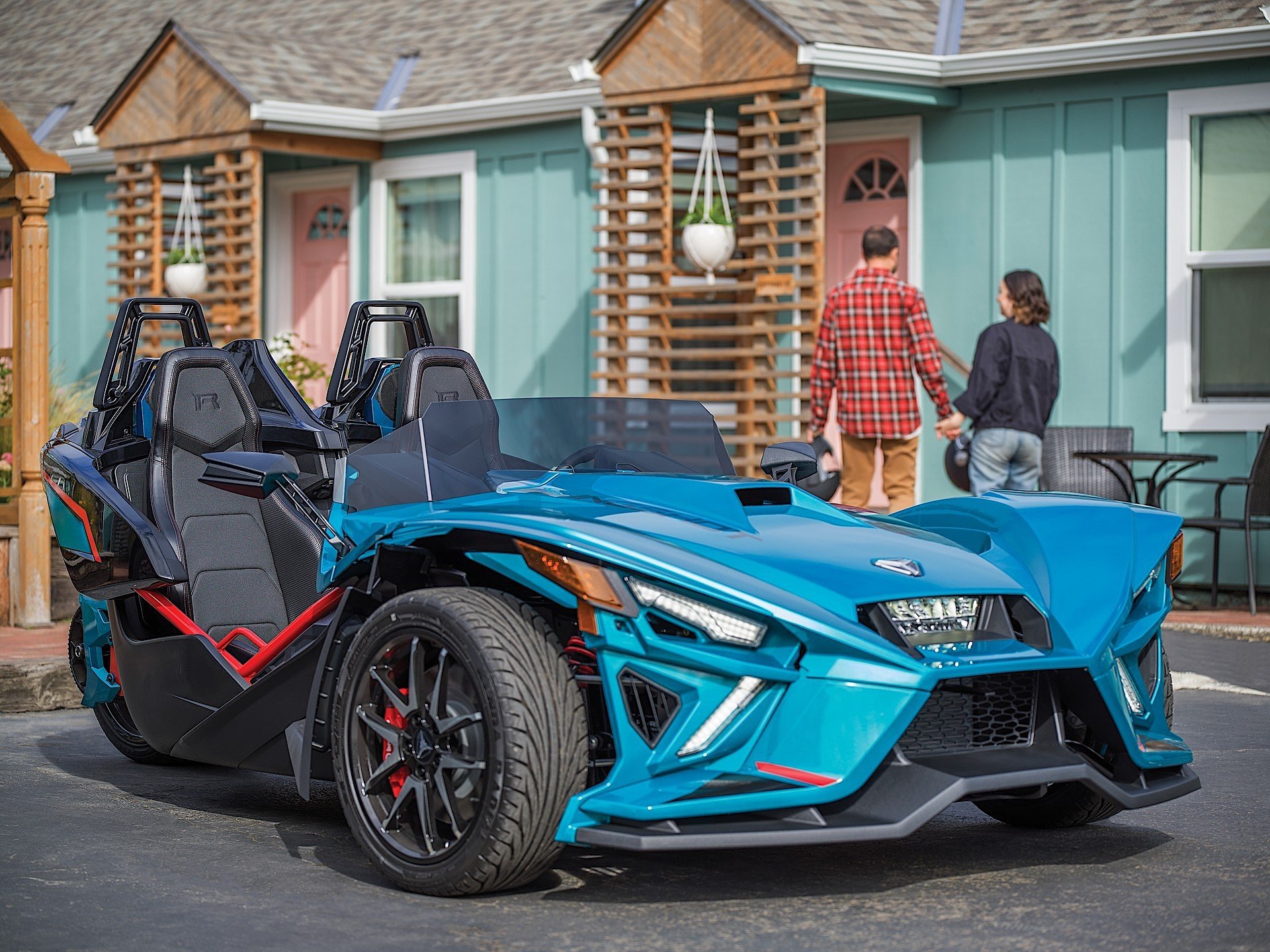 couple with slingshot vehicle