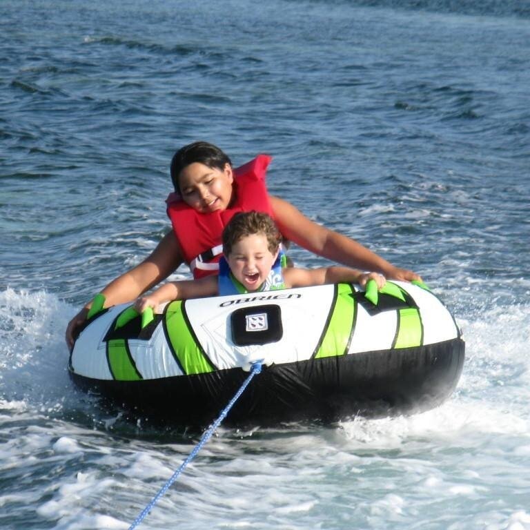 kids tubing on water