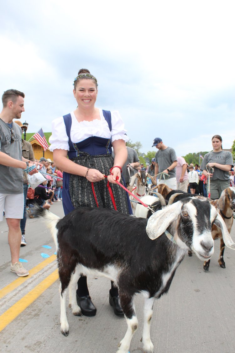 Woman with a goat the Annual Roofing of the Goats Parade and Festival