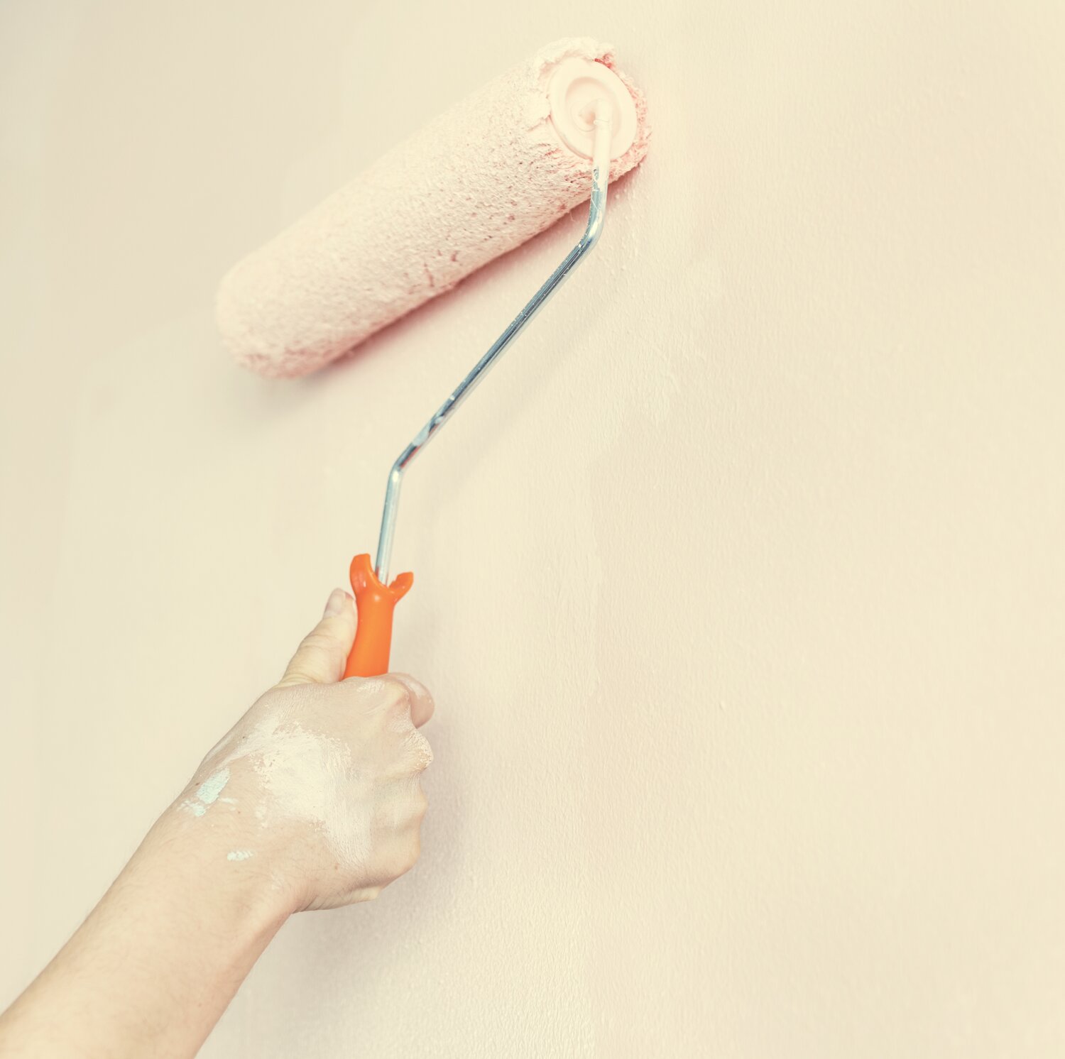 Peninsula Painting paint roller on wall