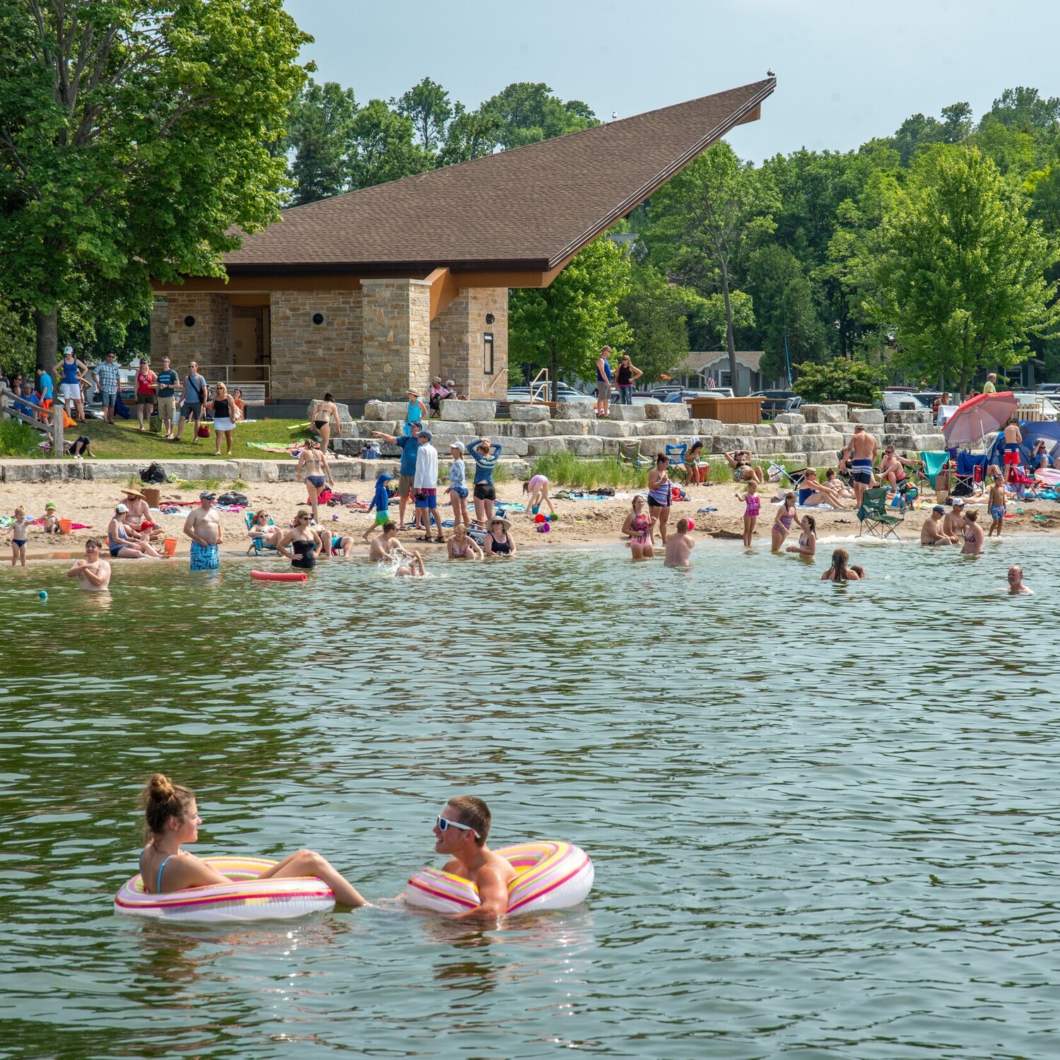 people swimming in Sister Bay Beach
