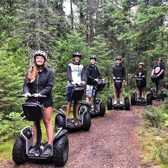 people on segways in the forest