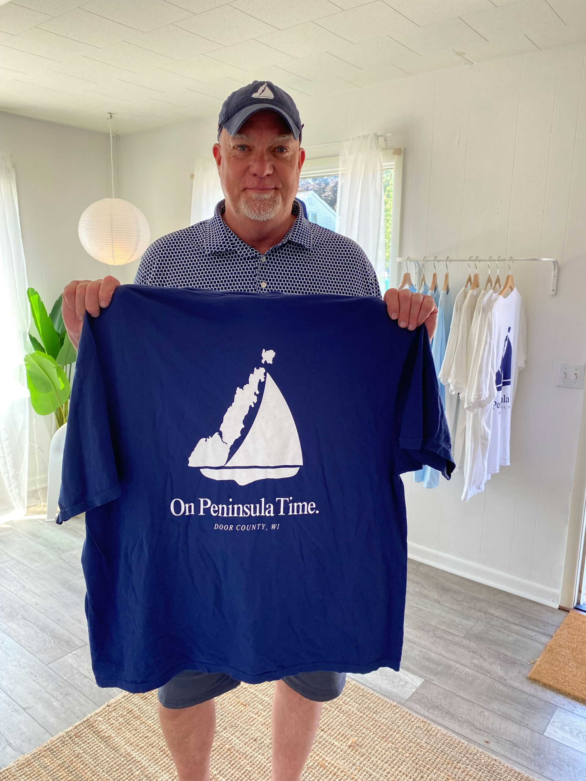 Man holding a shirt from the Door Stop