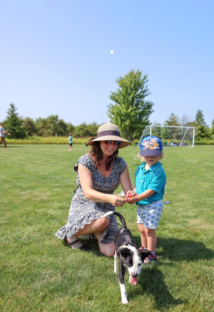 Mom and little boy flying a kite in Sister Bay