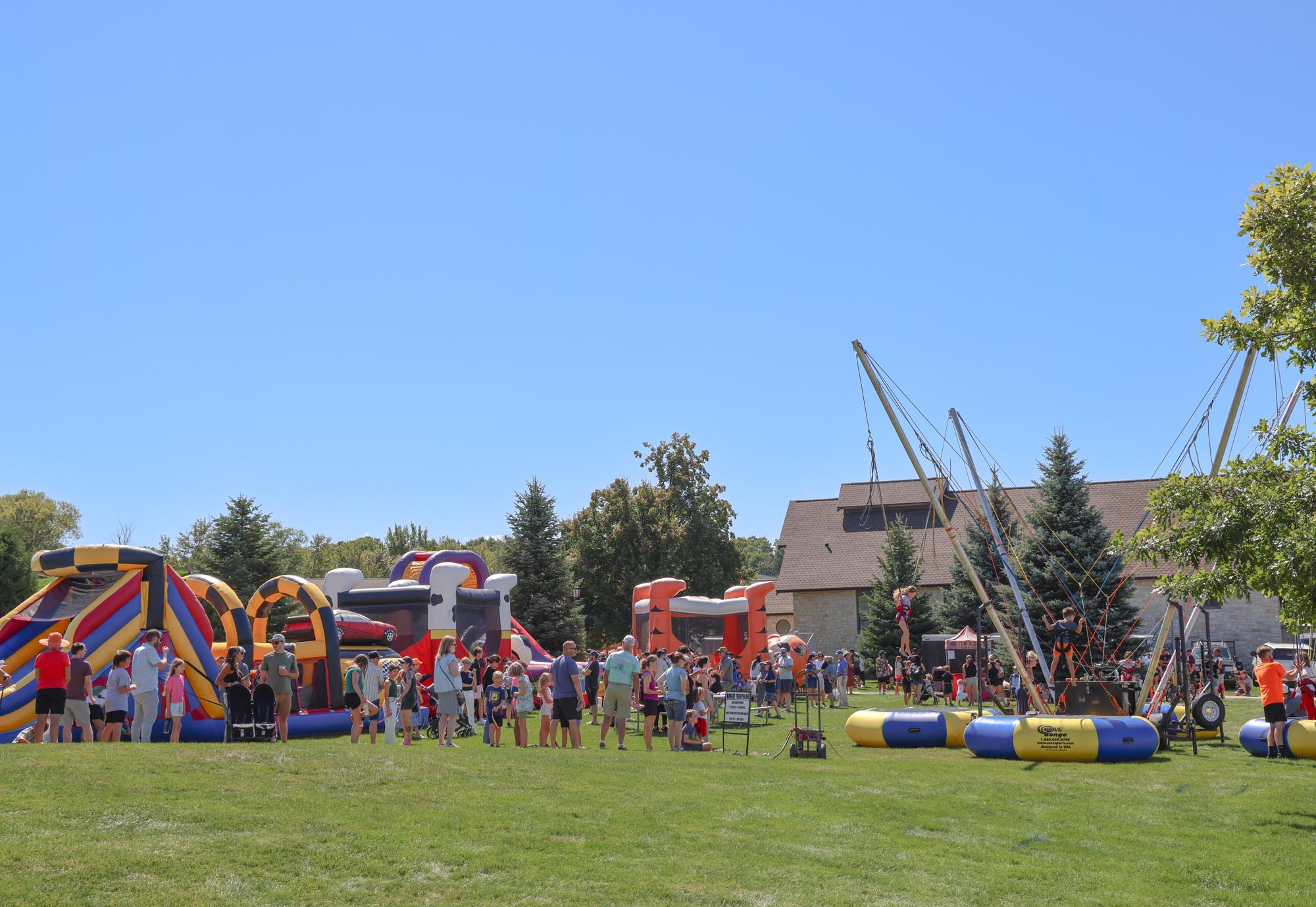 people playing on blow up bounce houses