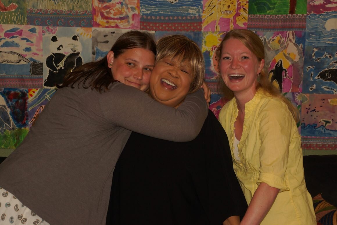 women hugging at Door Community Auditorium