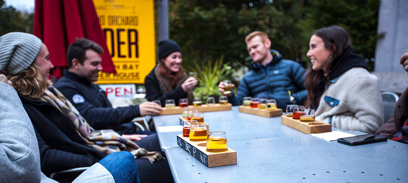 People enjoying cider outside from Island Orchard in Sister Bay
