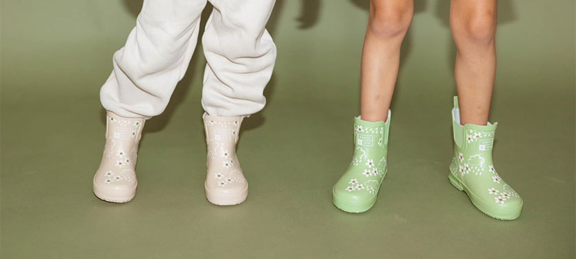 Feet of kids in boots from Little Rad House in Sister Bay