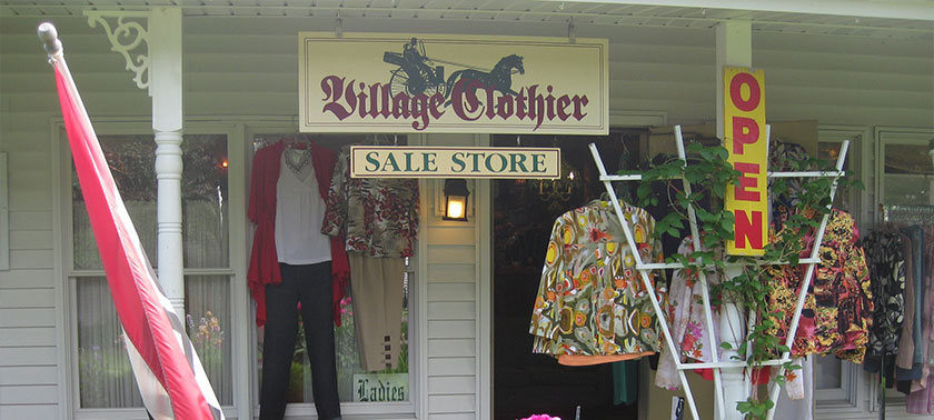 Front door and sign of Village Clothier in Sister Bay