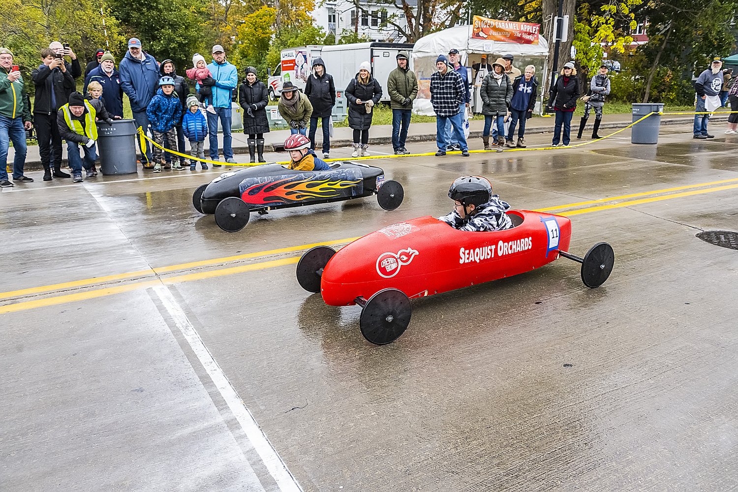 Two kids in derby cars at Sister Bay Fall Fest