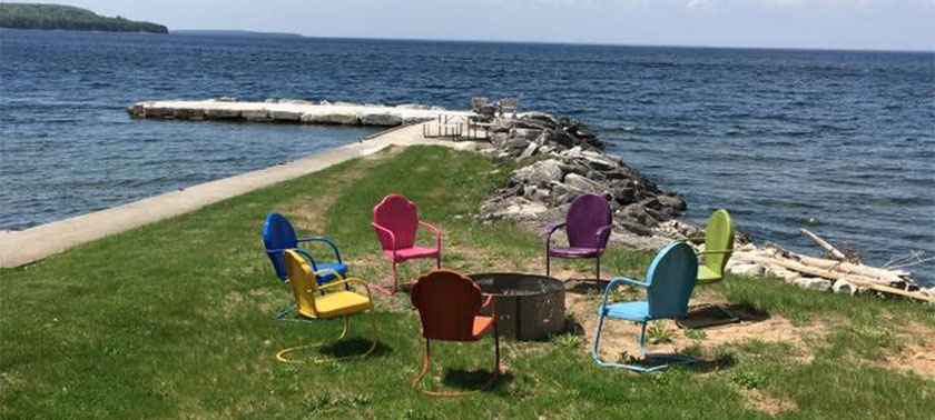patio chairs by fire pit at Island View Cottage
