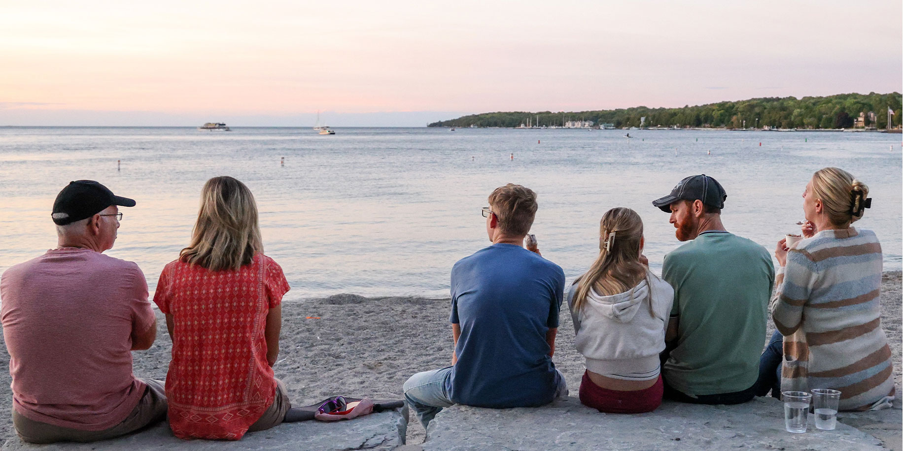 SisterBay-Website-About-1832x916_050125 A Family watching the sunset over the bay in Sister Bay