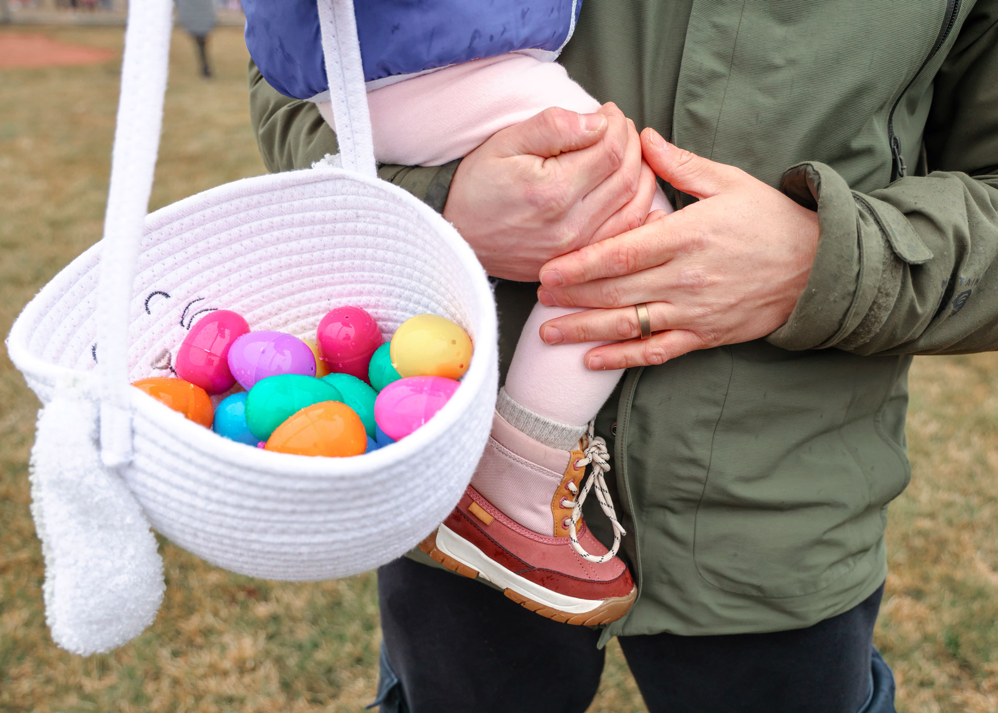 A dad holing his daughter with her basket full of eggs in Sister Bay