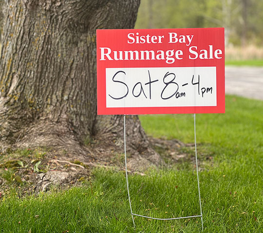 Sister Bay Rummage Sale sign with times