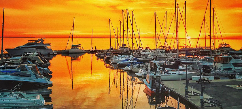 sunset on water with boats