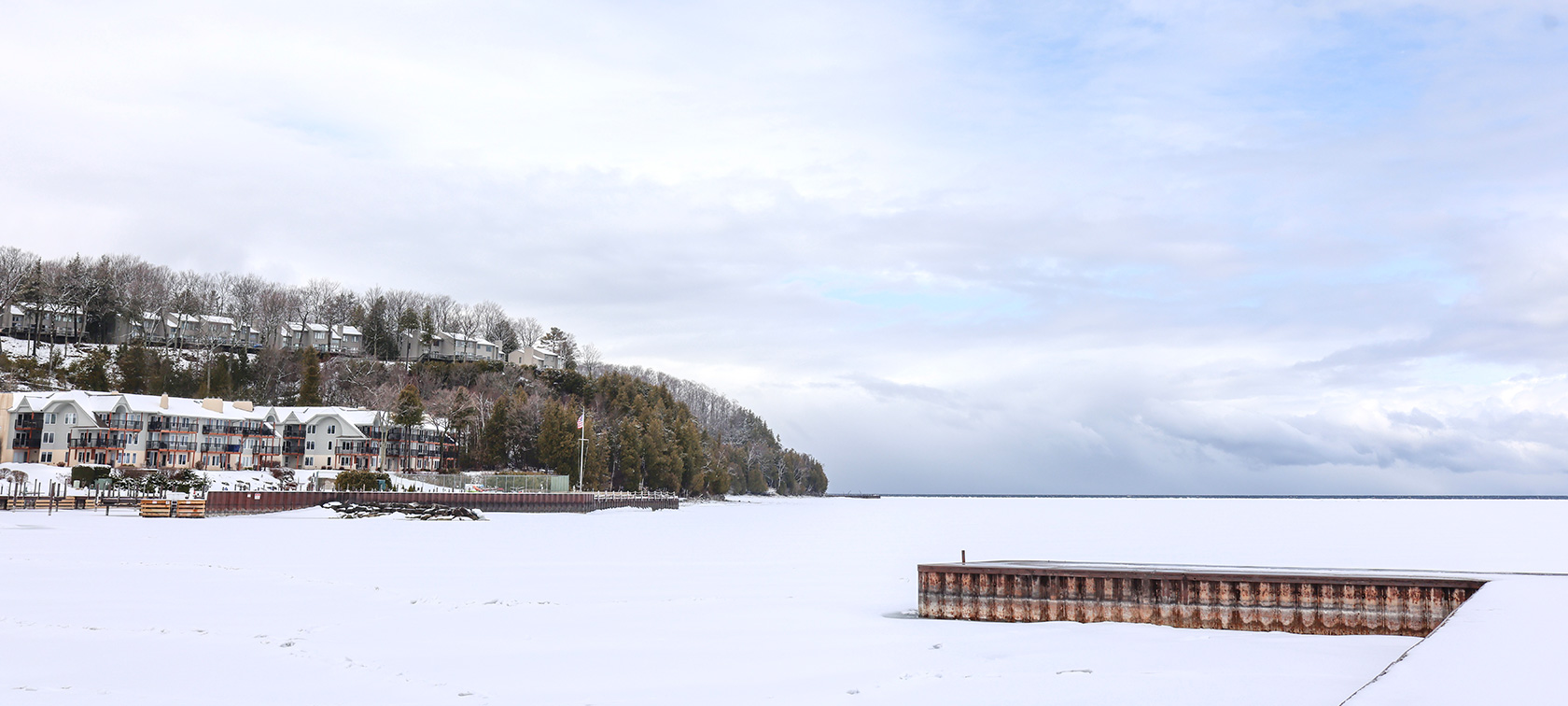View of Sister Bay beach in winter covered in snow